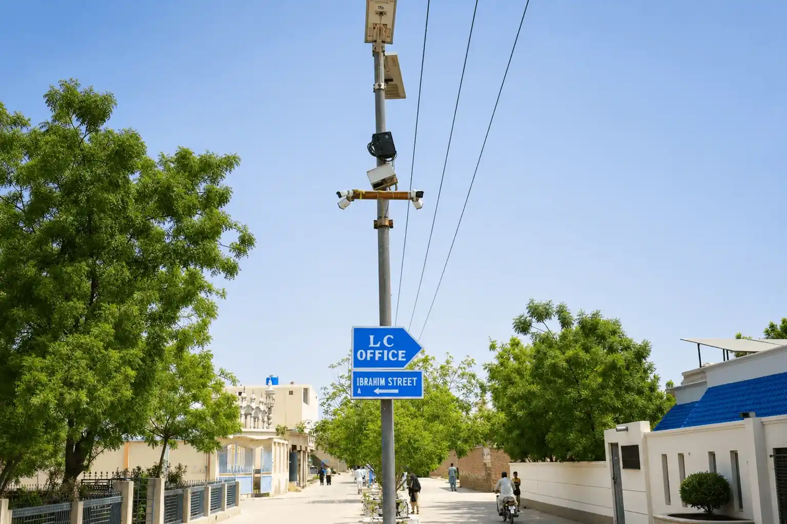 Shahrah-e-Umar main boulevard with paved road and street lights in Luhur Colony